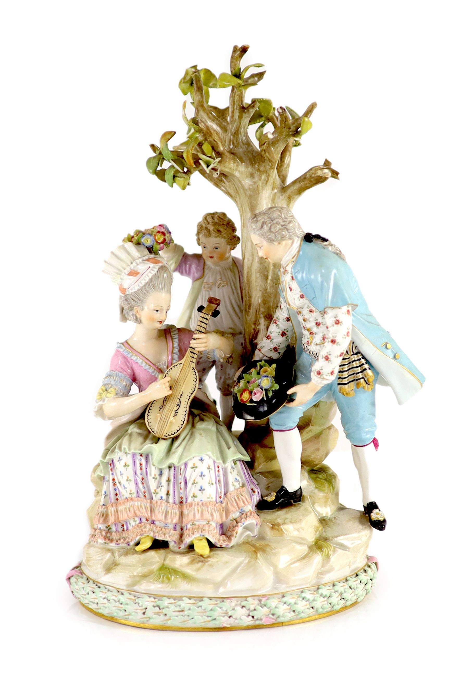 A Meissen group of flower pickers, 19th century, 26 cm high, losses to tree